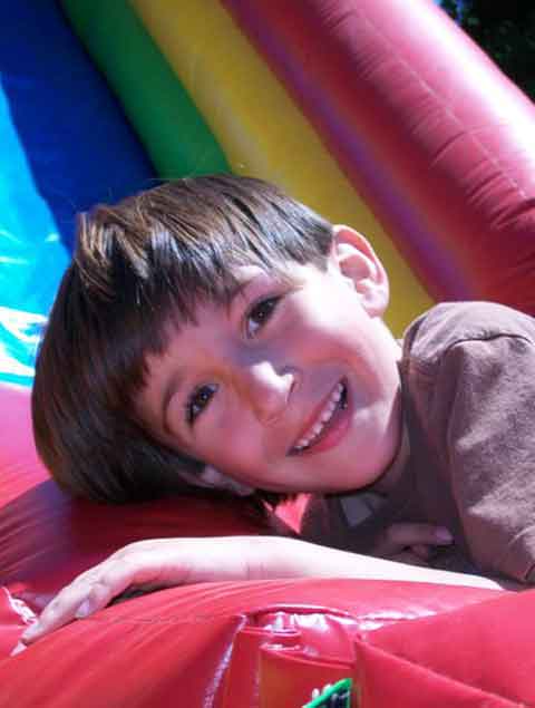 Happy boy on an inflatable slide at Pettit Creek Farms